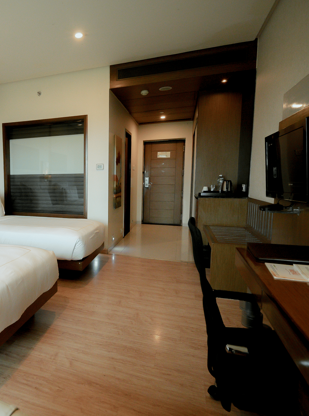 Executive room featuring a twin beds and a work desk at Narayani Heights Hotel & Resorts, Ahmedabad.