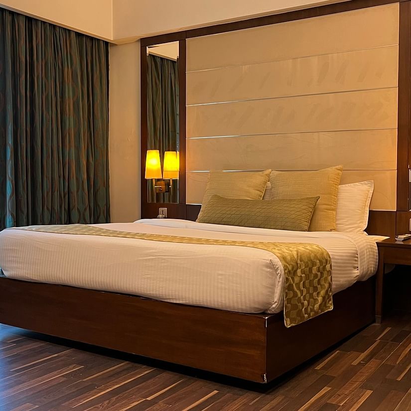 cosy bedroom with luxurious interior and aesthetic lighting where the bed is placed next to floor-to-ceiling window and wooden floor - yuhi mansion Suite Room1