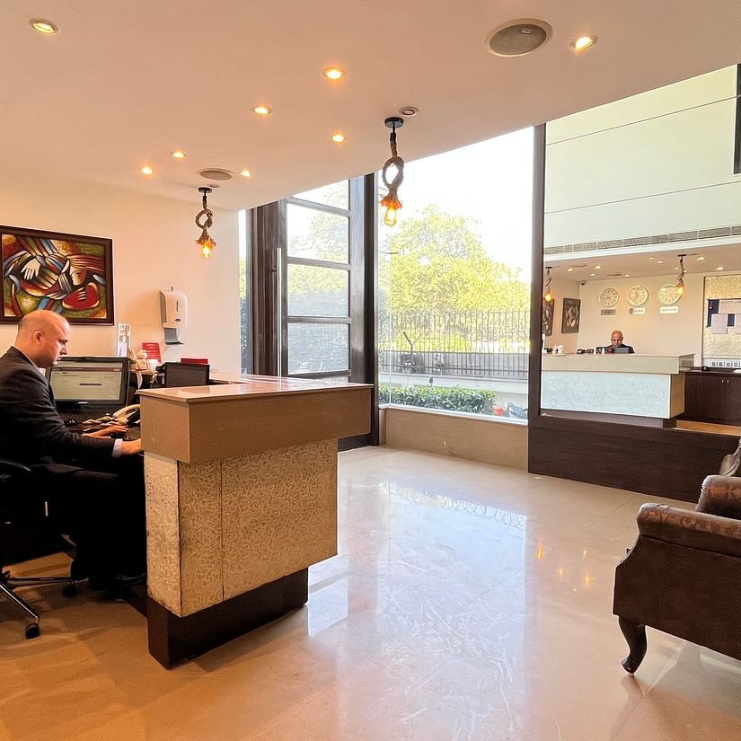 the reception desk at yuhi mansions shot from different angles showcasing a staff working while wearing a suite3