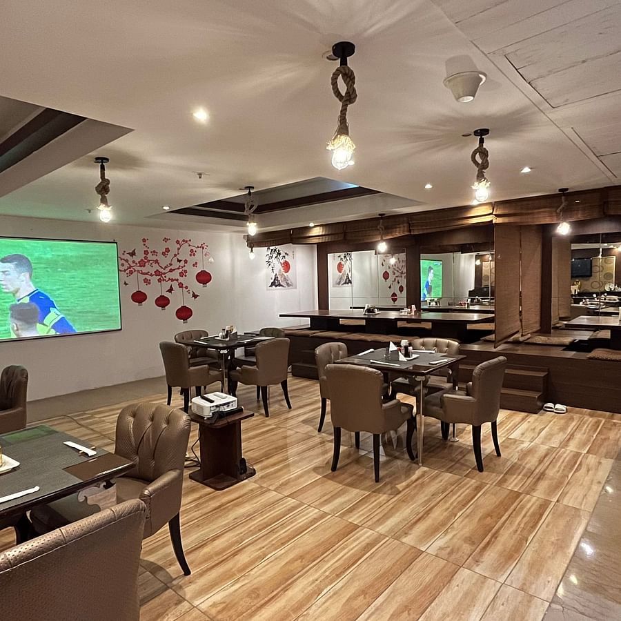 restaurant area at Yuhi Mansions showcasing 100 22 LED screen for live sports telecast along with spacious indoor seating arangement1