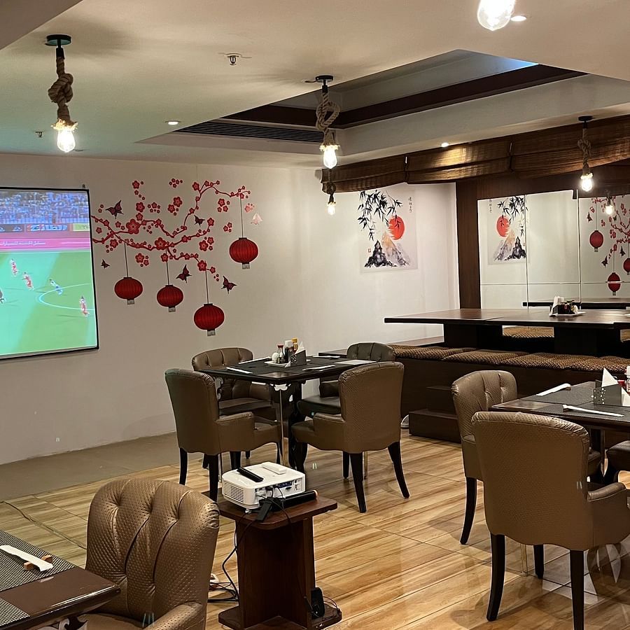 restaurant area at Yuhi Mansions showcasing 100 22 LED screen for live sports telecast along with spacious indoor seating arangement2
