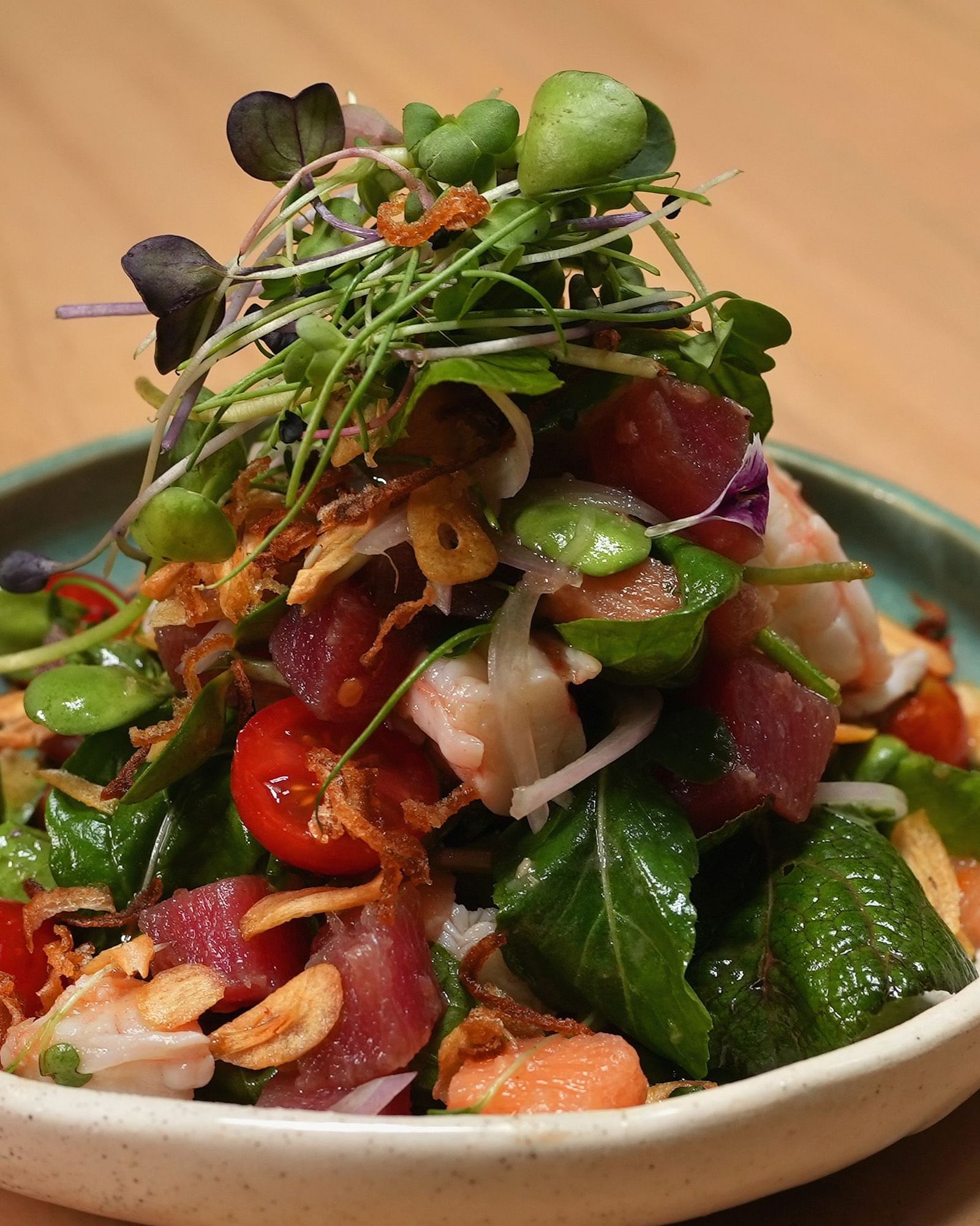 Fish salad  served in a small round green and white bowl