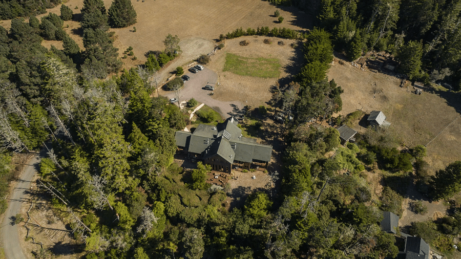 Aerial view of an inn in Mendocino covered by lush green trees - Brewery Gulch Inn & Spa