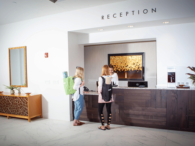 The reception area at YO1 Longevity & Health Resorts, with staff welcoming guests to the wellness retreat