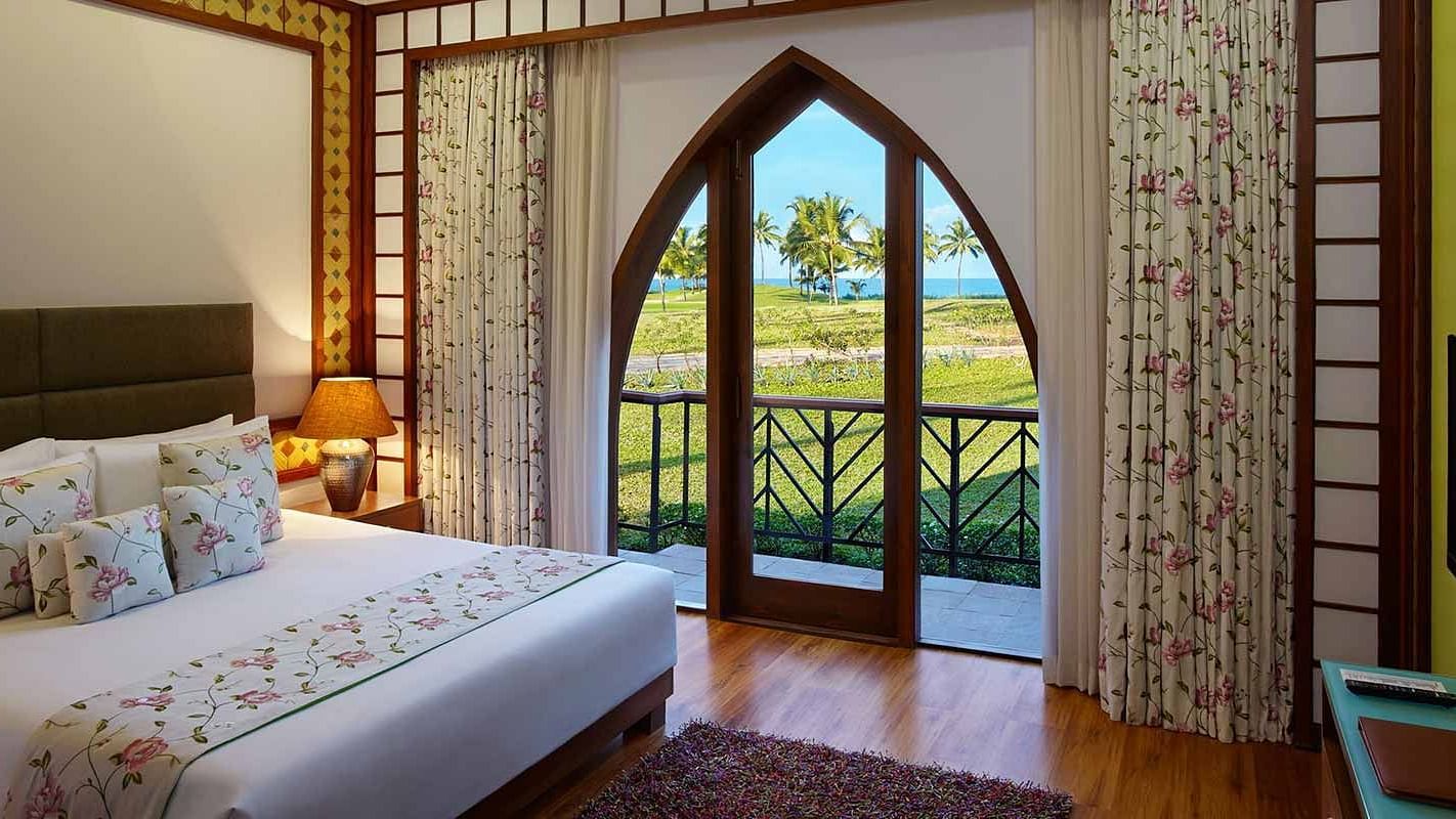 a double bed with side tables, lamps inside family villa - Caravela Beach Resort Goa