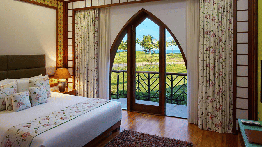 a double bed with access to the balcony inside family villa - Caravela Beach Resort Goa