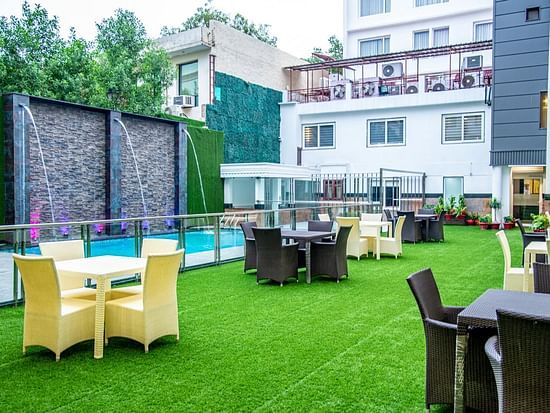 Chairs and tables placed in an open event space beside a pool Sun Park Hotel & Banquet, Chandigarh - Zirakpur