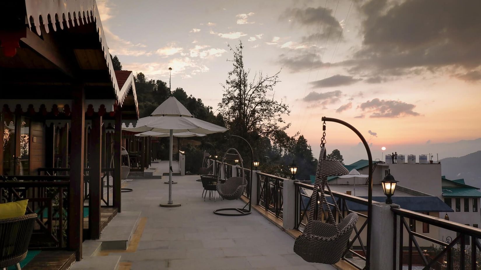 Balcony sitting area with admirable view and blue-red sky