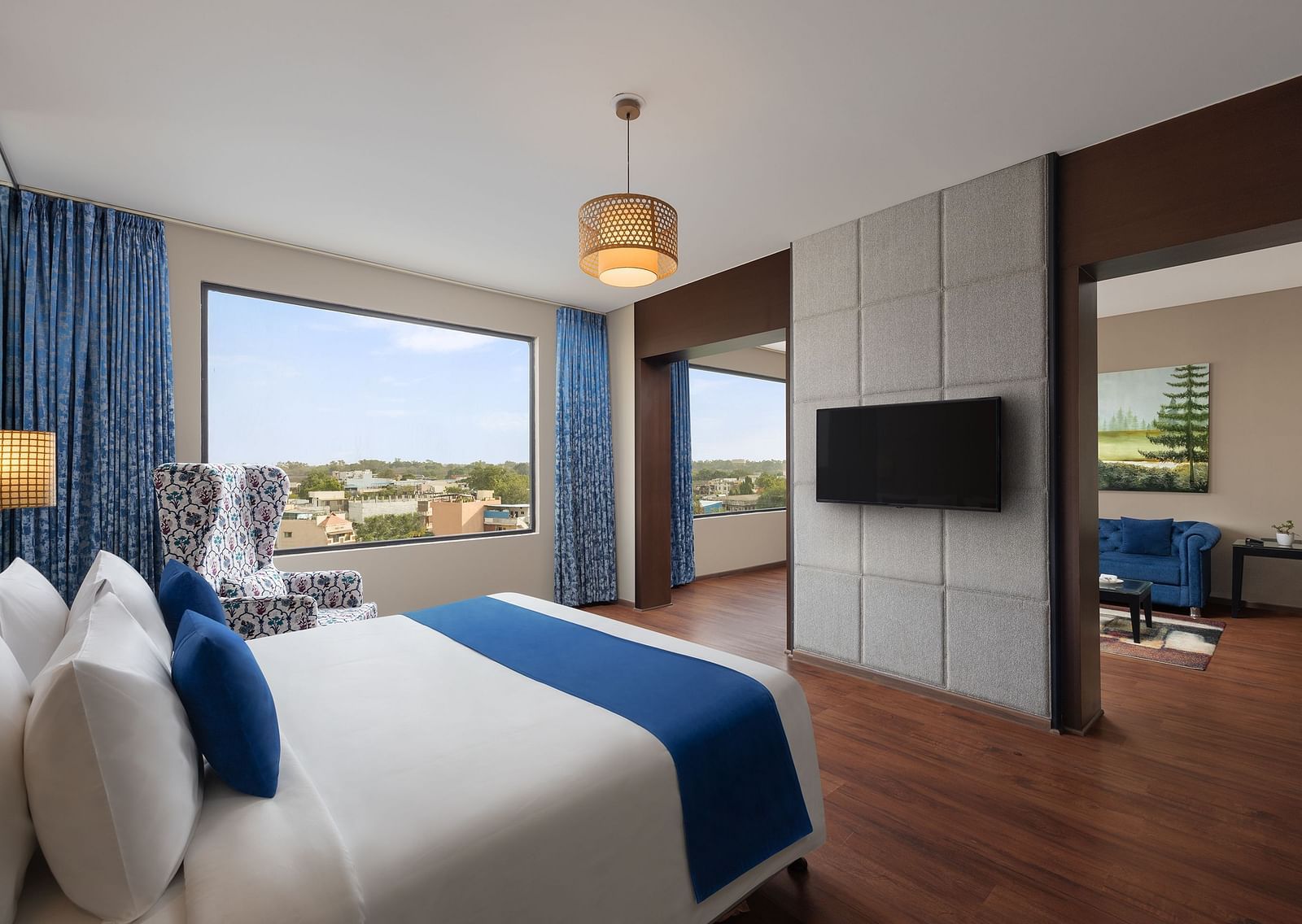 Dleuxe Suite at Essentia Luxury Hotel, Indore with a double bed, a television and a separate living area
