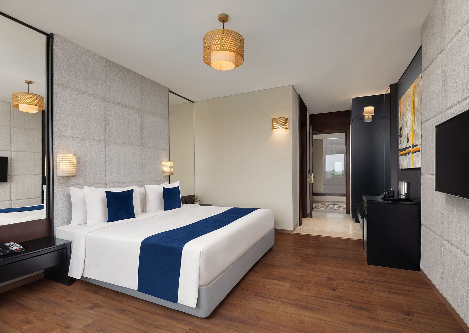 Premium Room at Essentia Luxury Hotel, Indore with a double bed and a television