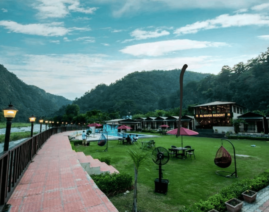 A far-angle view of DLS MJ River Resort, Rishikesh with a garden view .