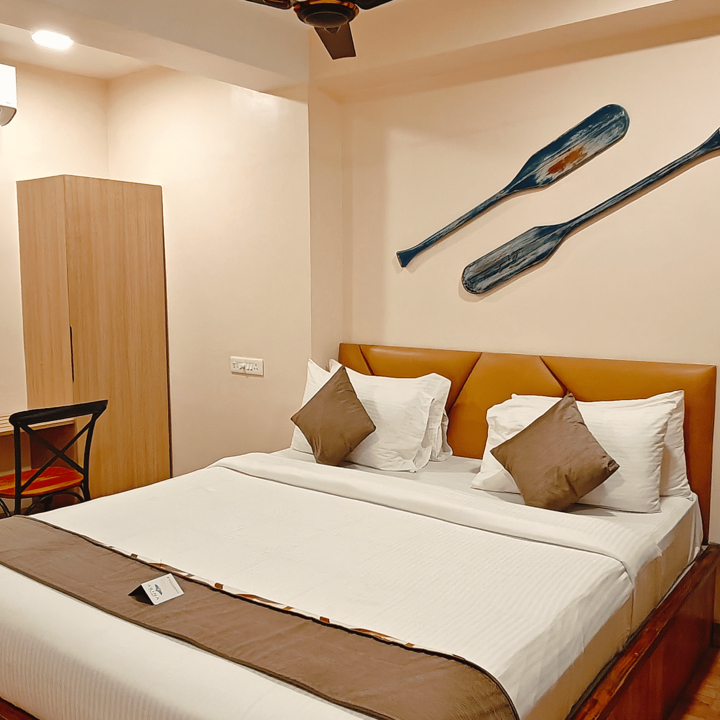 A well-furnished bedroom at Barren Villa featuring a double bed, side table, and a work desk with warm lighting