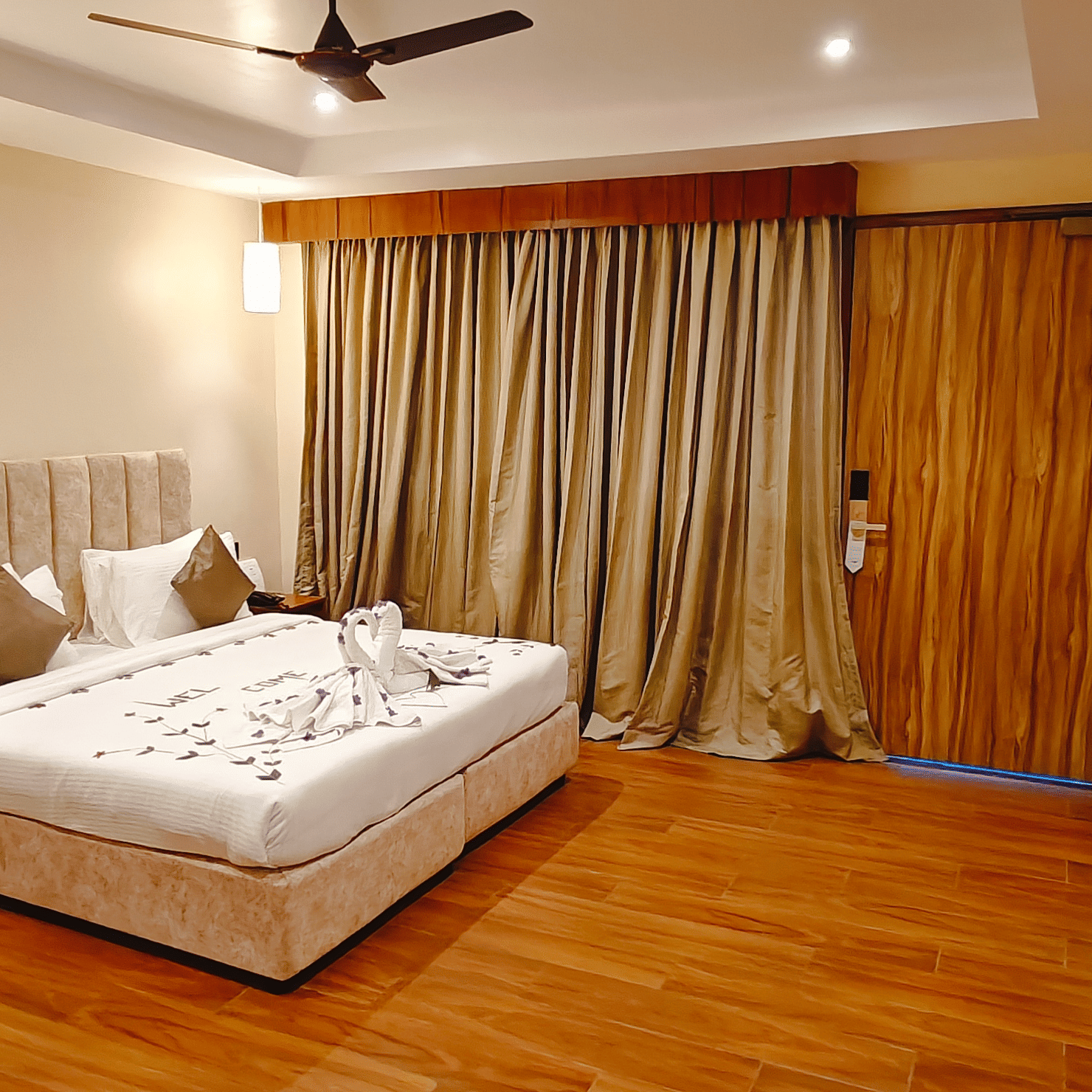 A warm bedroom at Ross Villa with a comfortable bed, wooden flooring, and soft lighting