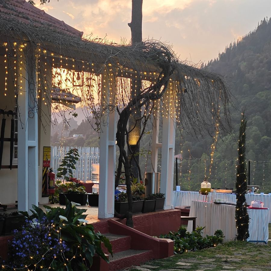 Outdoor wedding reception area at dusk with string lights and a covered porch in Coonoor - Ibex Stays & Trails, Coonoor (Leewood).