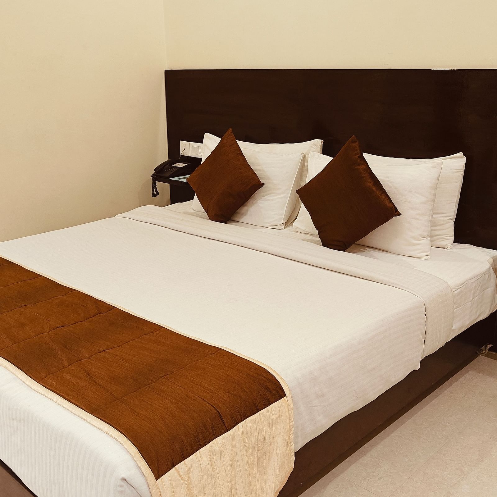 Neat single-bed room with minimalist decor at Hotel Alps Residency, Krishnagiri.