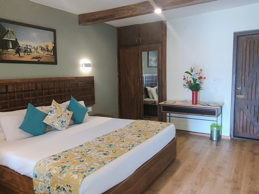 room with a king size bed and wooden flooring