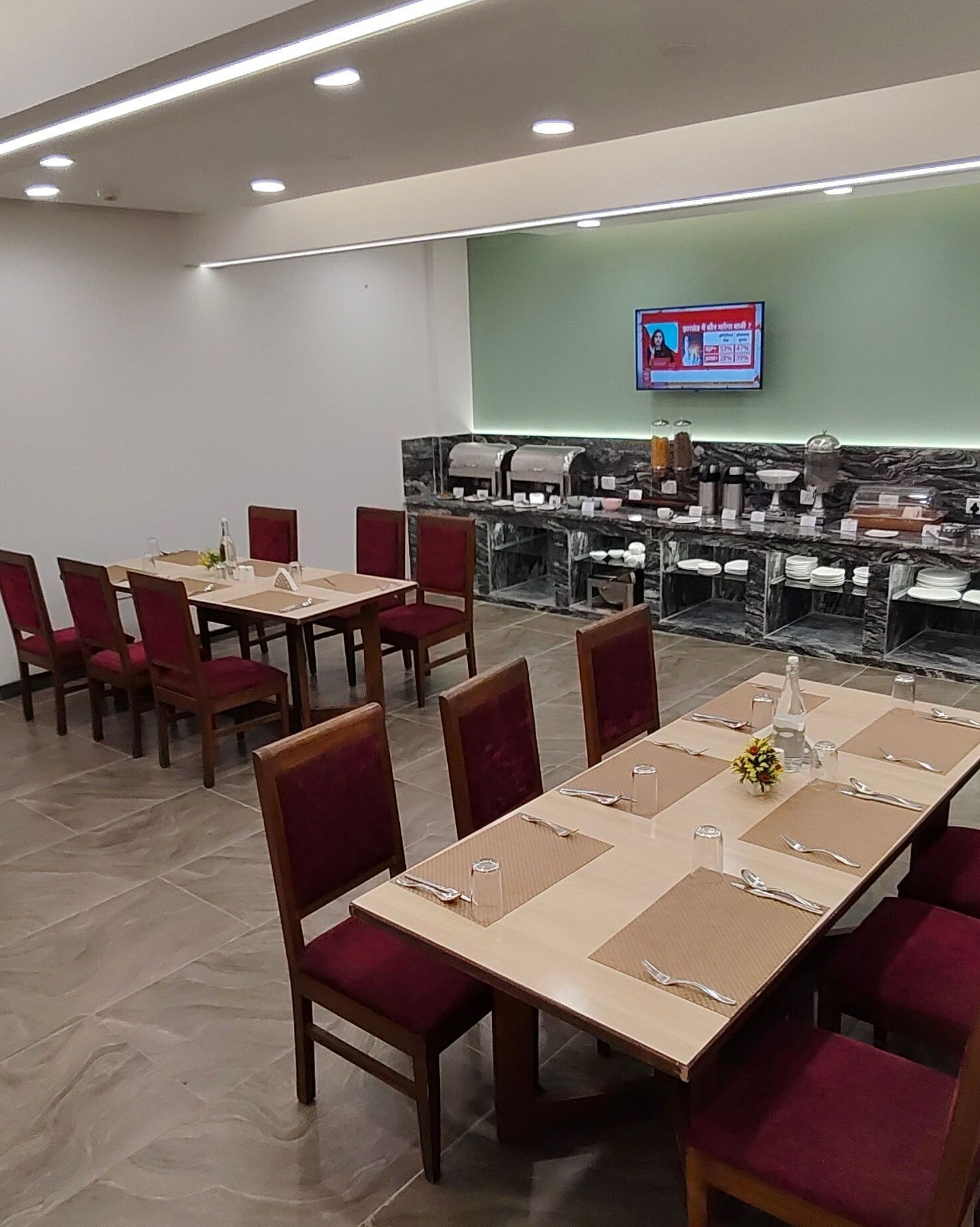 Restaurant-style dining area with red chairs and wooden tables