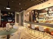 Shot of the lounge at our hotel featuring dim lighting with a bar counter. | Mirage Hotel