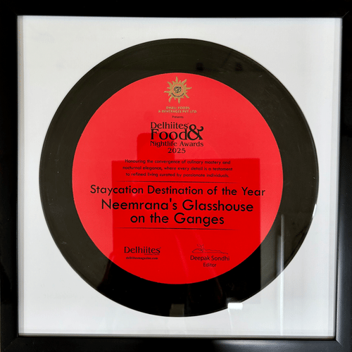 Framed award plaque for 'Staycation Destination of the Year 2025' awarded to Neemrana's Glasshouse on the Ganges by Delhiites Food & Nightlife Awards.
