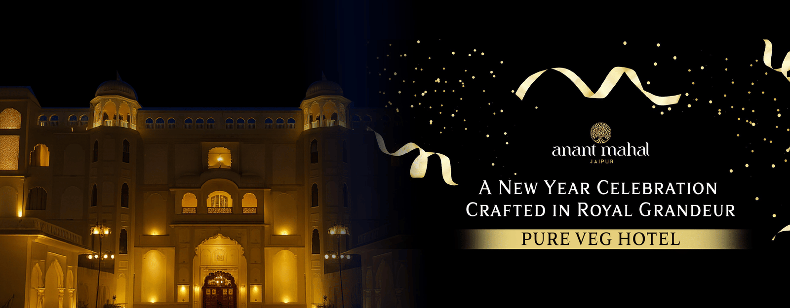 Banner for New Year Celebration at Anant Mahal, Jaipur featuring its facade lit up during night time with the text - Pure Veg Hotel