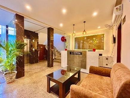 The reception area at Five Elements Hotels, Haridwar featuring a sofa, a coffee table, and the reception desk