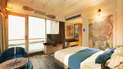 Bright coastal themed bedroom with ocean view