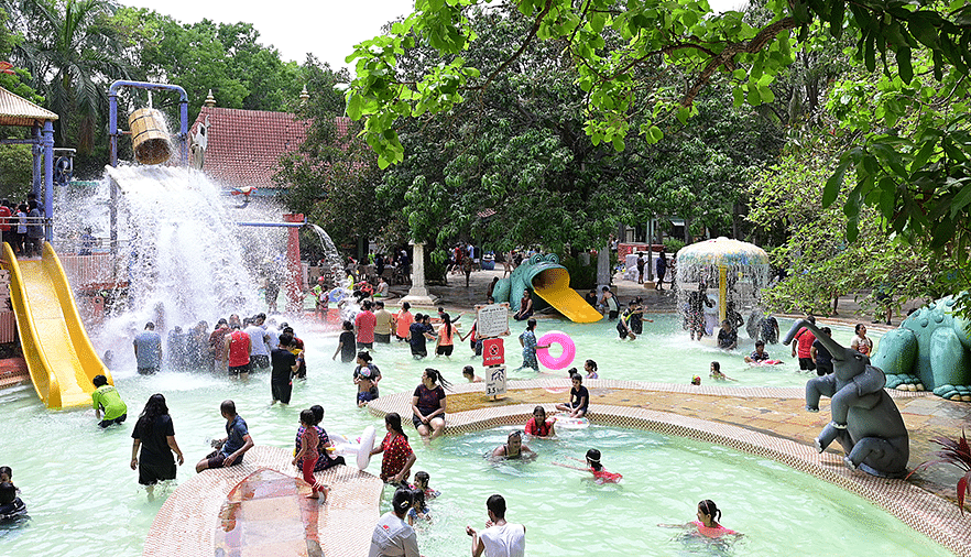 Water Kingdom - A group of people enjoying in a pool at our water park during daytime