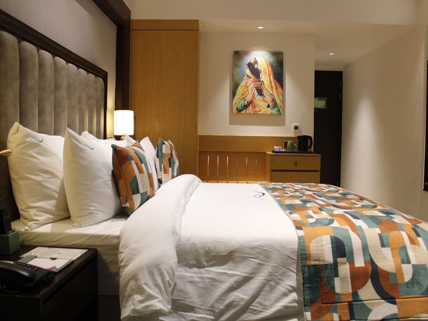 A bedroom with a painting hanging on the wall at BluSalzz Residence, Amritsar.