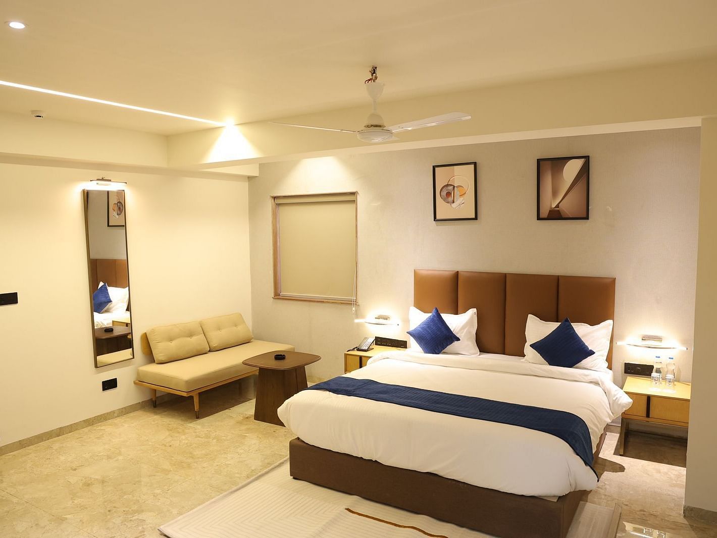 A well appointed bedroom at Lords Eco inn Jamnagar Maheshwari Nagar featuring a large bed and elegant decor.