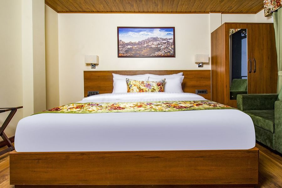 Suite With Balcony room with a cosy bed and wardrobe in the corner at Mount Lungta Boutique Hotel & Spa