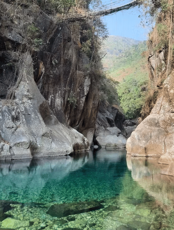 A lake with huge stones beside it.