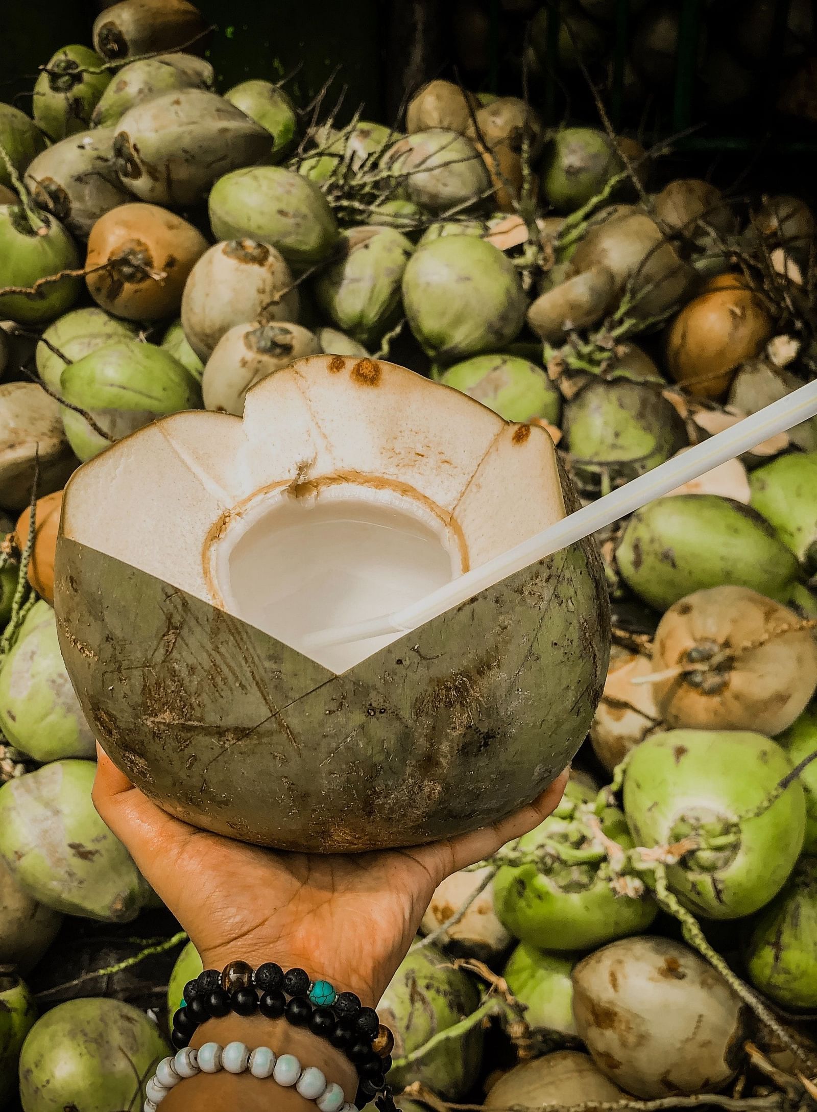 a person holding a coconut