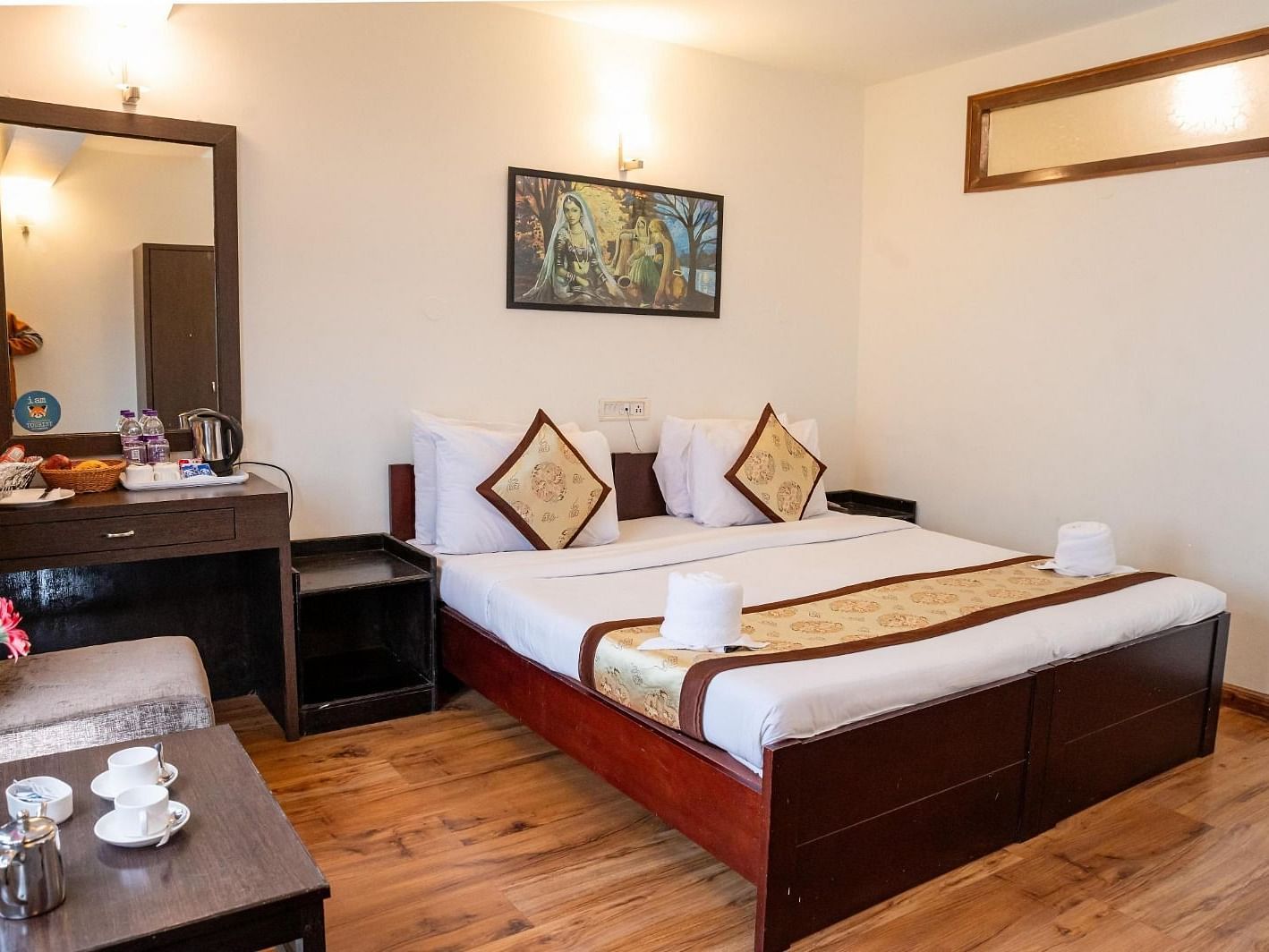 A full view shot of the Deluxe Room with a half length mirror beside the bed and the bed side table at Sumitel Sanderling.
