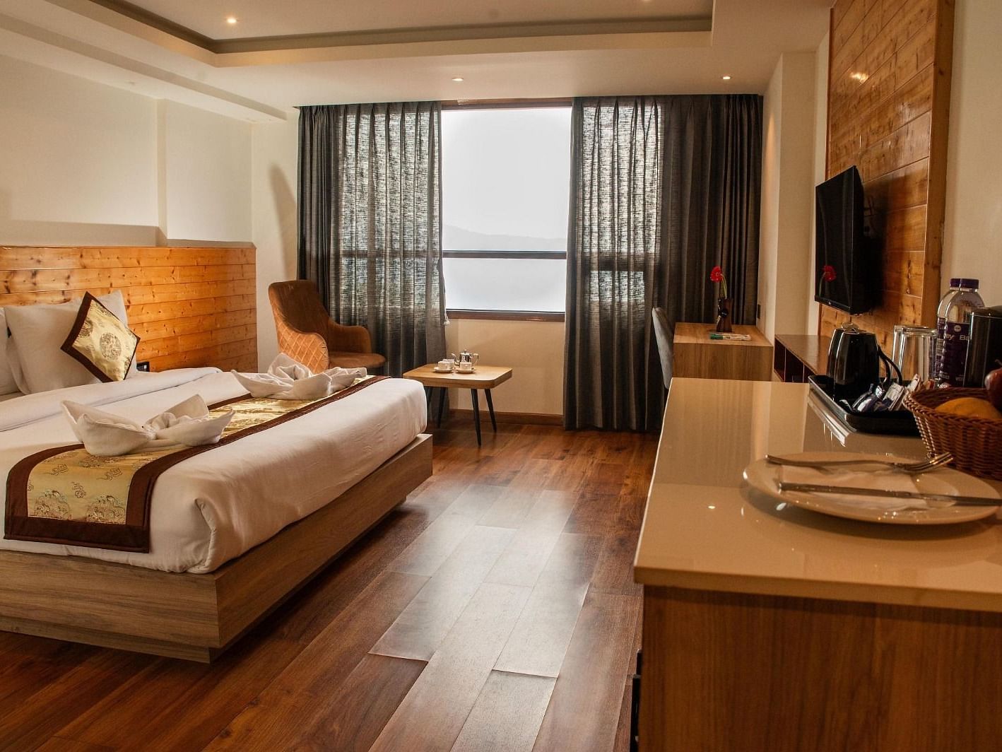 Full view shot of the Suite at Sumitel Sanderling featuring a double bed along with a window emitting plenty of natural light.