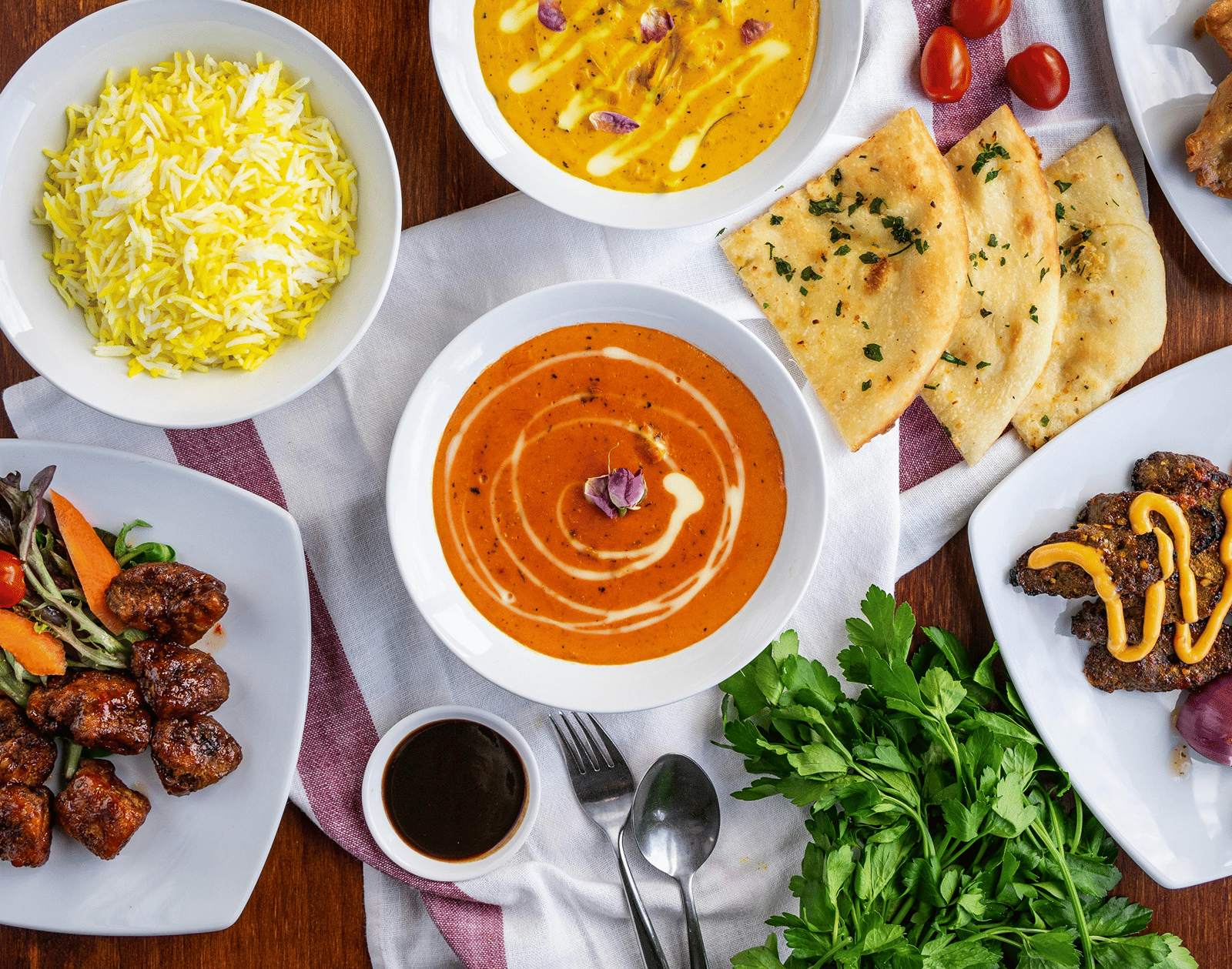 A top shot of a delicious spread of various Indian dishes served on a table.