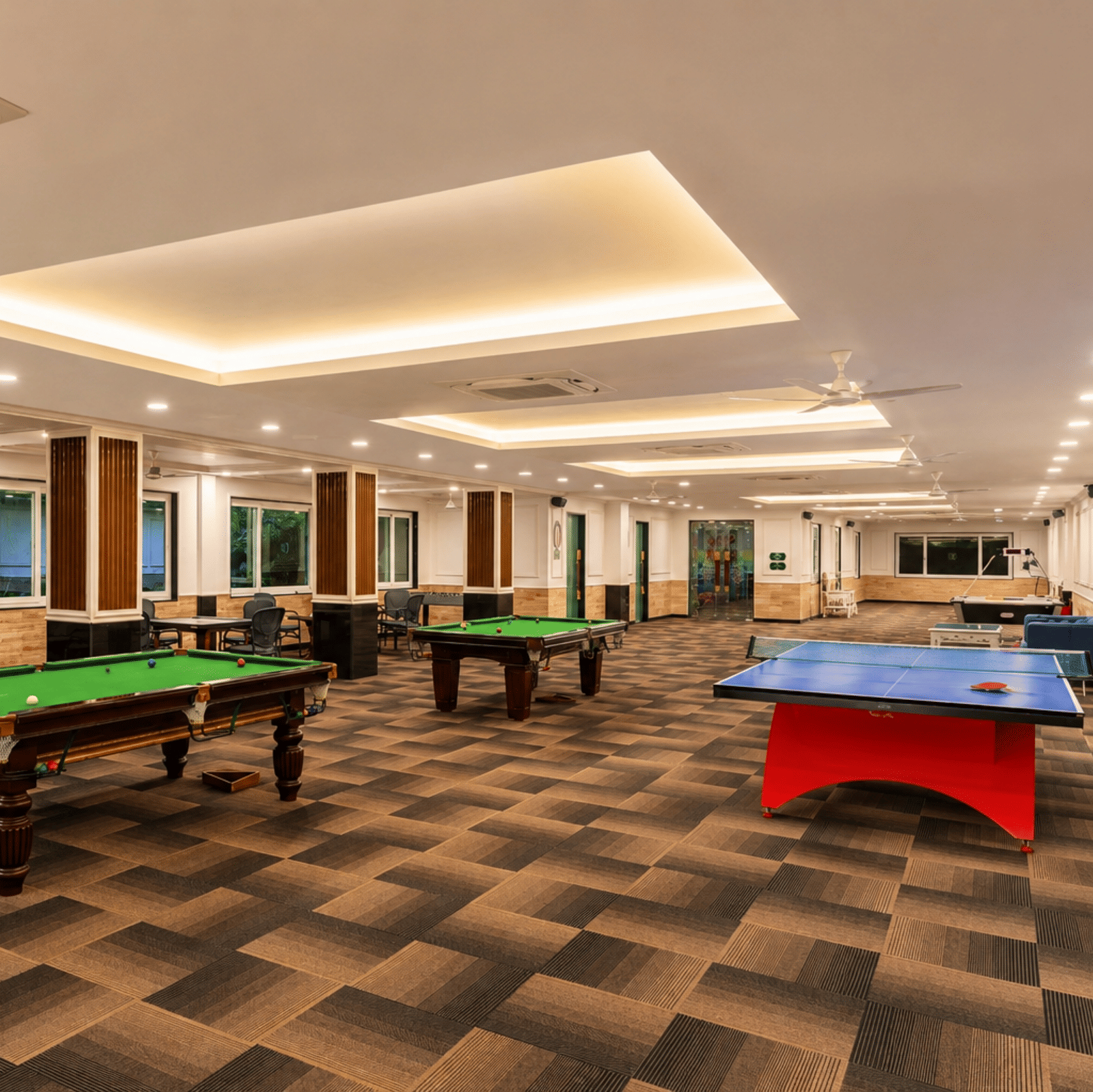 Indoor game zone with two billiards tables, a table-tennis table, foosball and air-hockey tables at MAYFAIR Palm Beach Resort, Gopalpur-on-Sea.