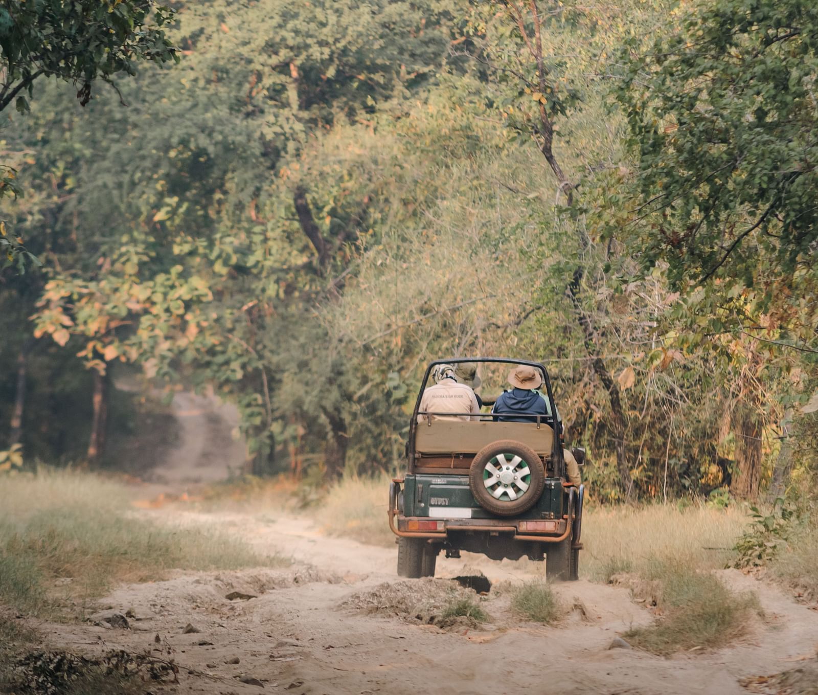 A Jeep travelling on a mud road on a safari ride at Trees N Tigers, Tadoba.