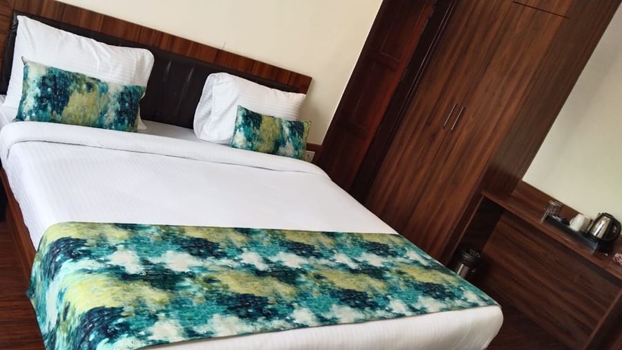 A double bed inside the Deluxe room -  Kolkata