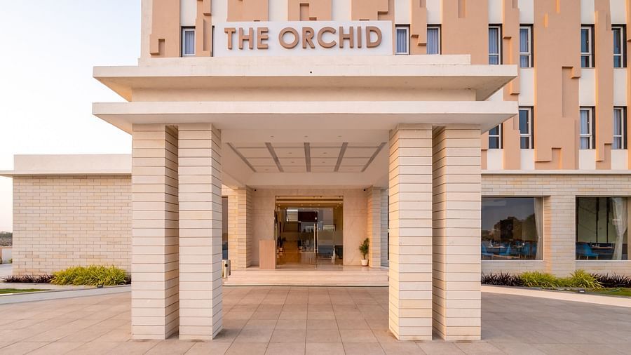 Entrance to the hotel with the signage of The Orchid above - The Orchid Hotel, Jamnagar