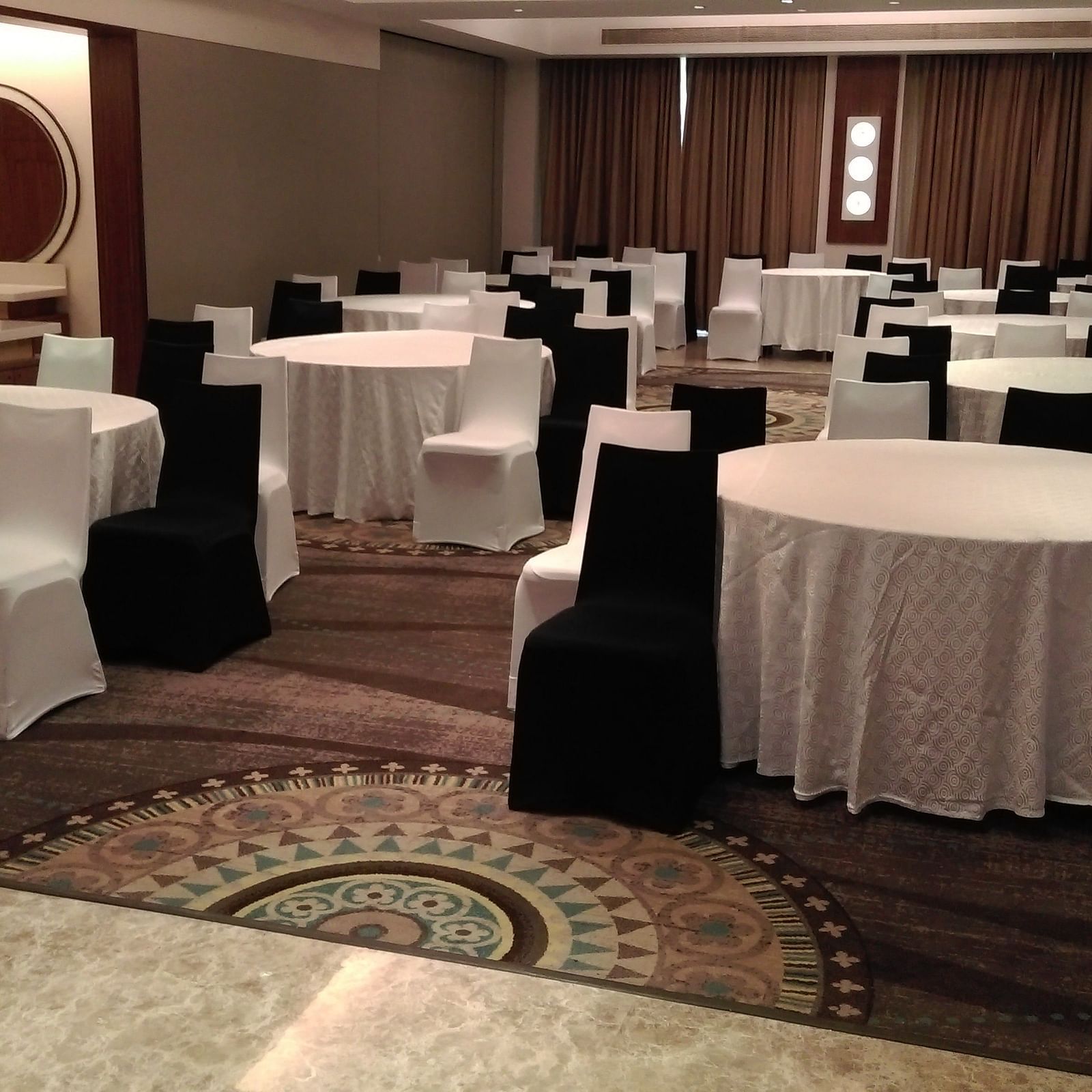 A hall with round tables and chairs around it The Raintree Hotel, St. Mary's Road.