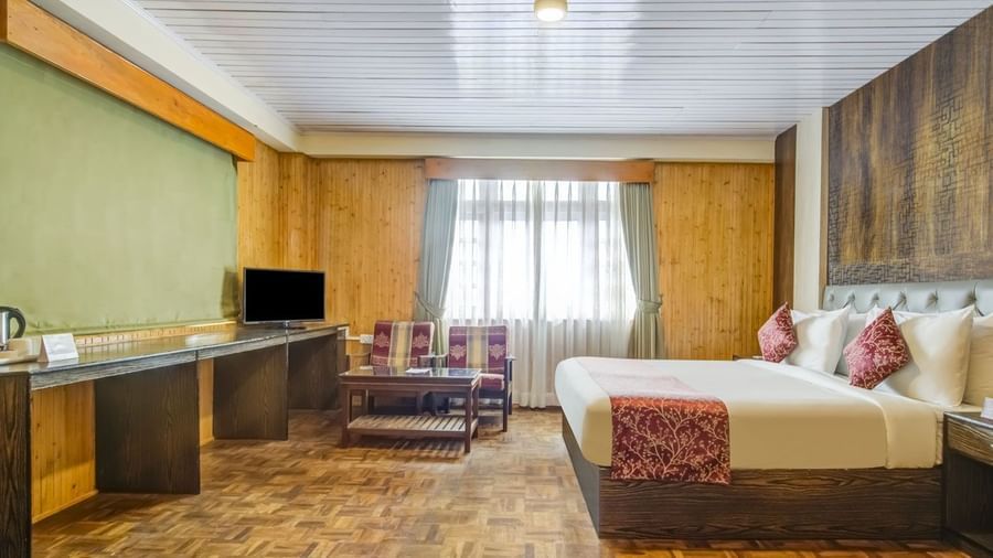 Image of a room with bed and television in front at Summit Tashi Ghang Heritage Resort, Pelling