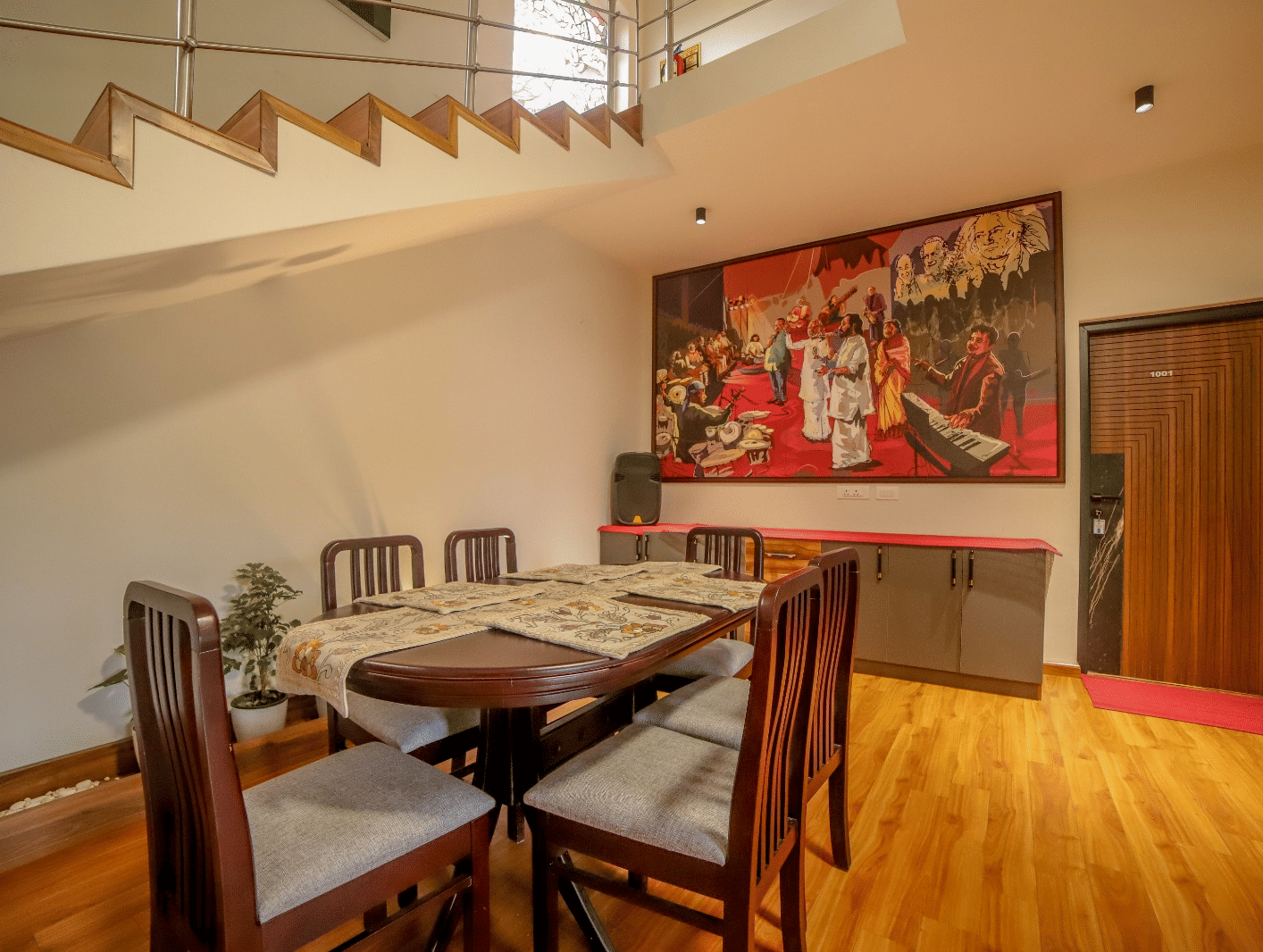 A large wooden table placed in the dining area with wooden flooring at MYST Resorts, Doddabetta, Ooty.