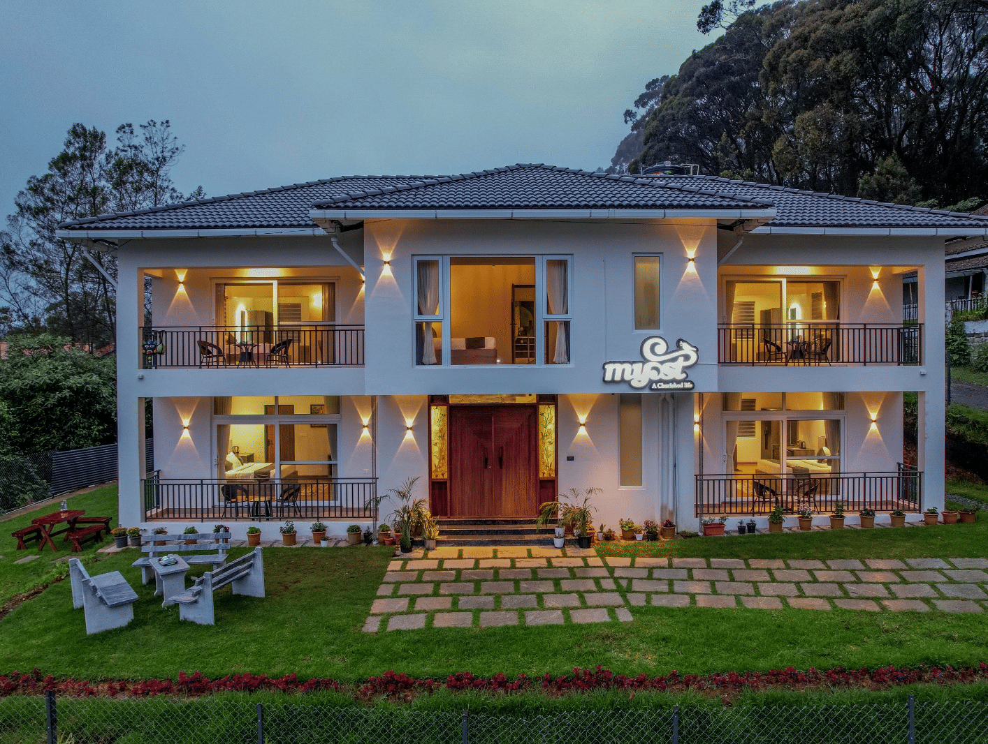 Well-lit, 2-storey MYST Resorts, Doddabetta, Ooty as seen from outside on a dull day.