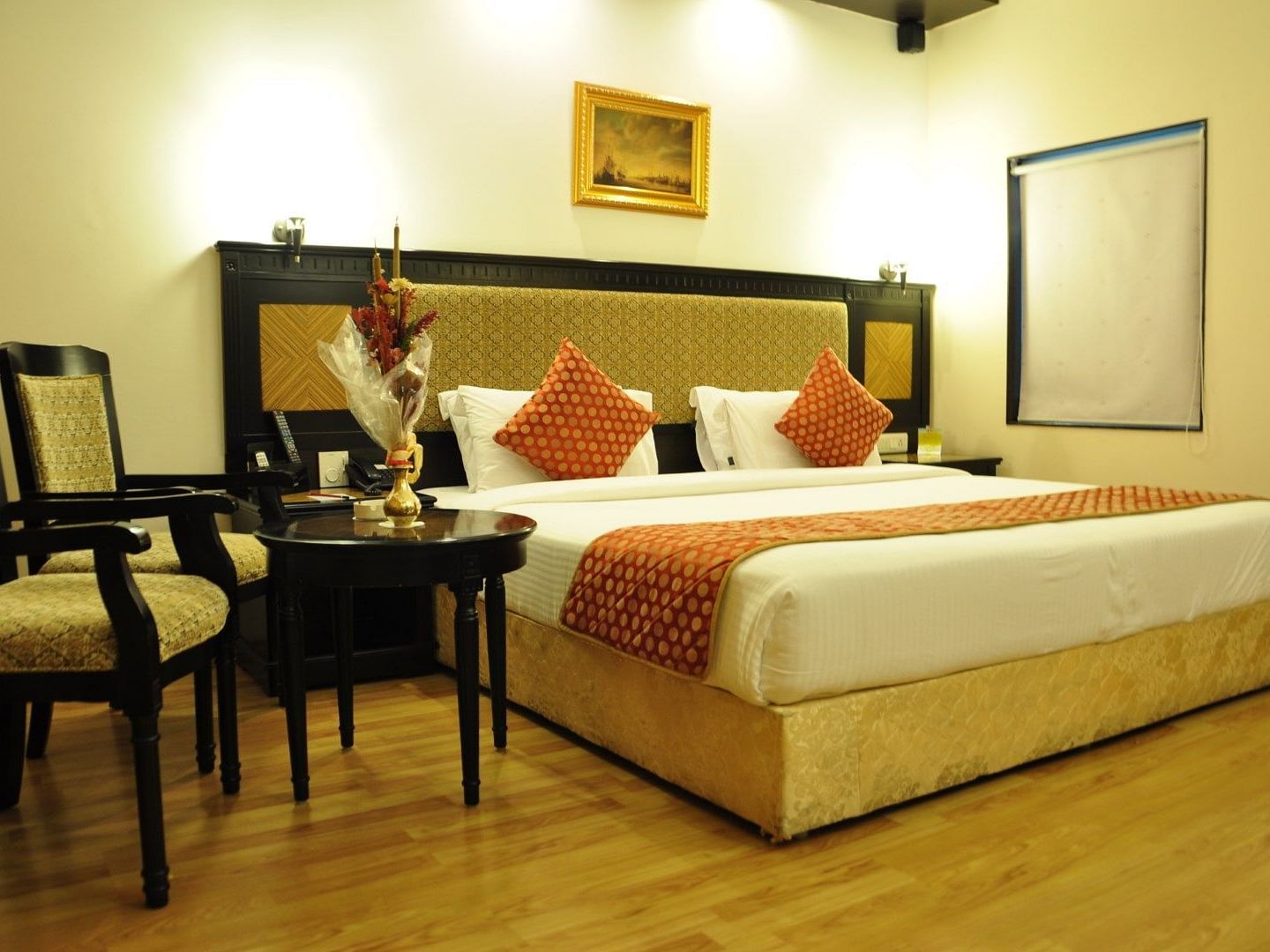 Royal Suites with comfortable bed and chairs at SRM Hotel Trichy