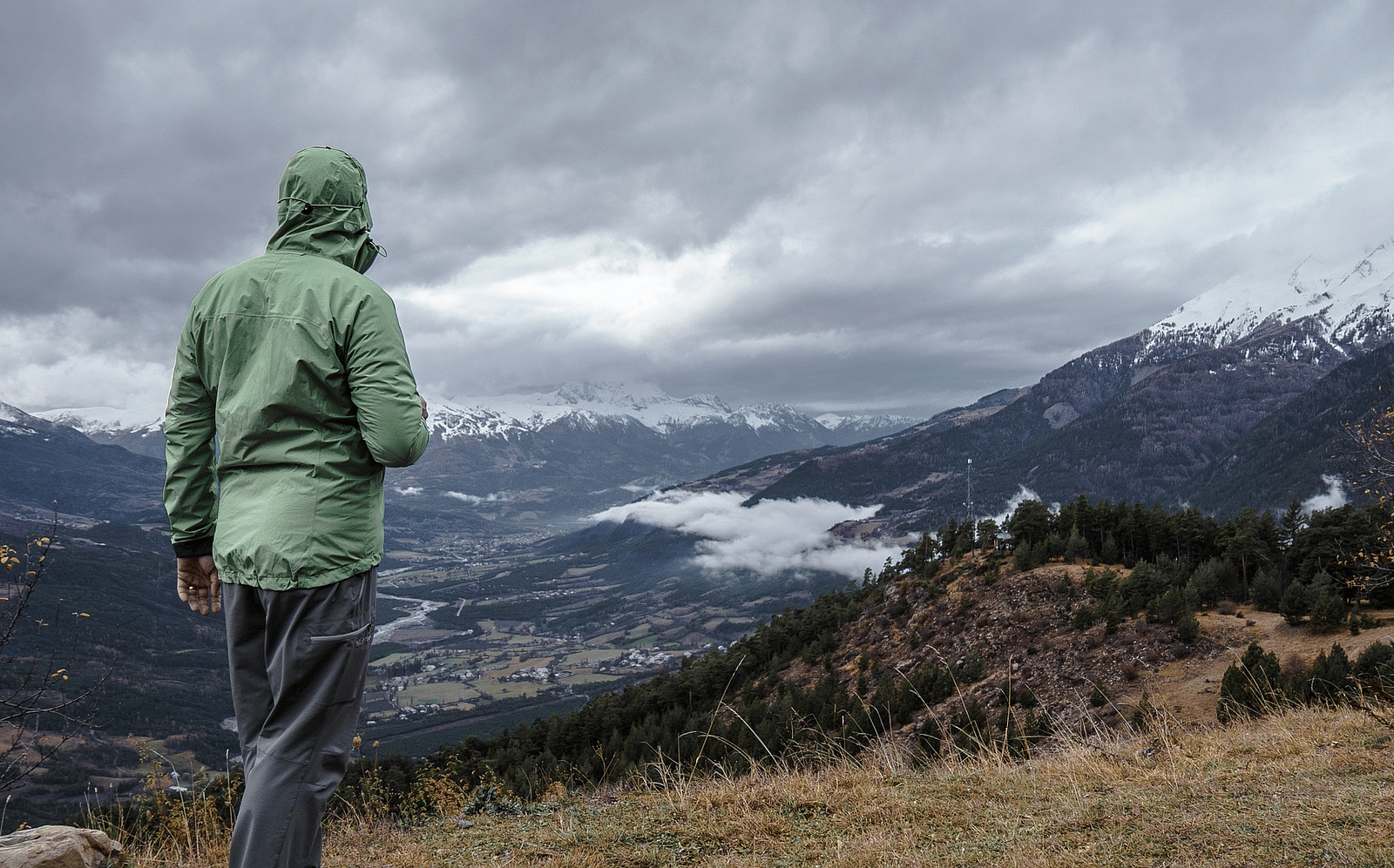 Person hiking through a scenic mountain trail.