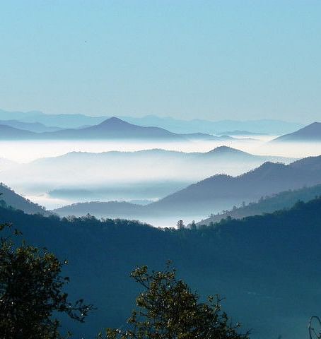An image of mountain peaks covered by clouds