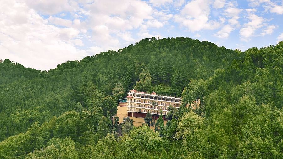 A long shot of JK Clarks Exotica in Dalhousie amidst lush greenery