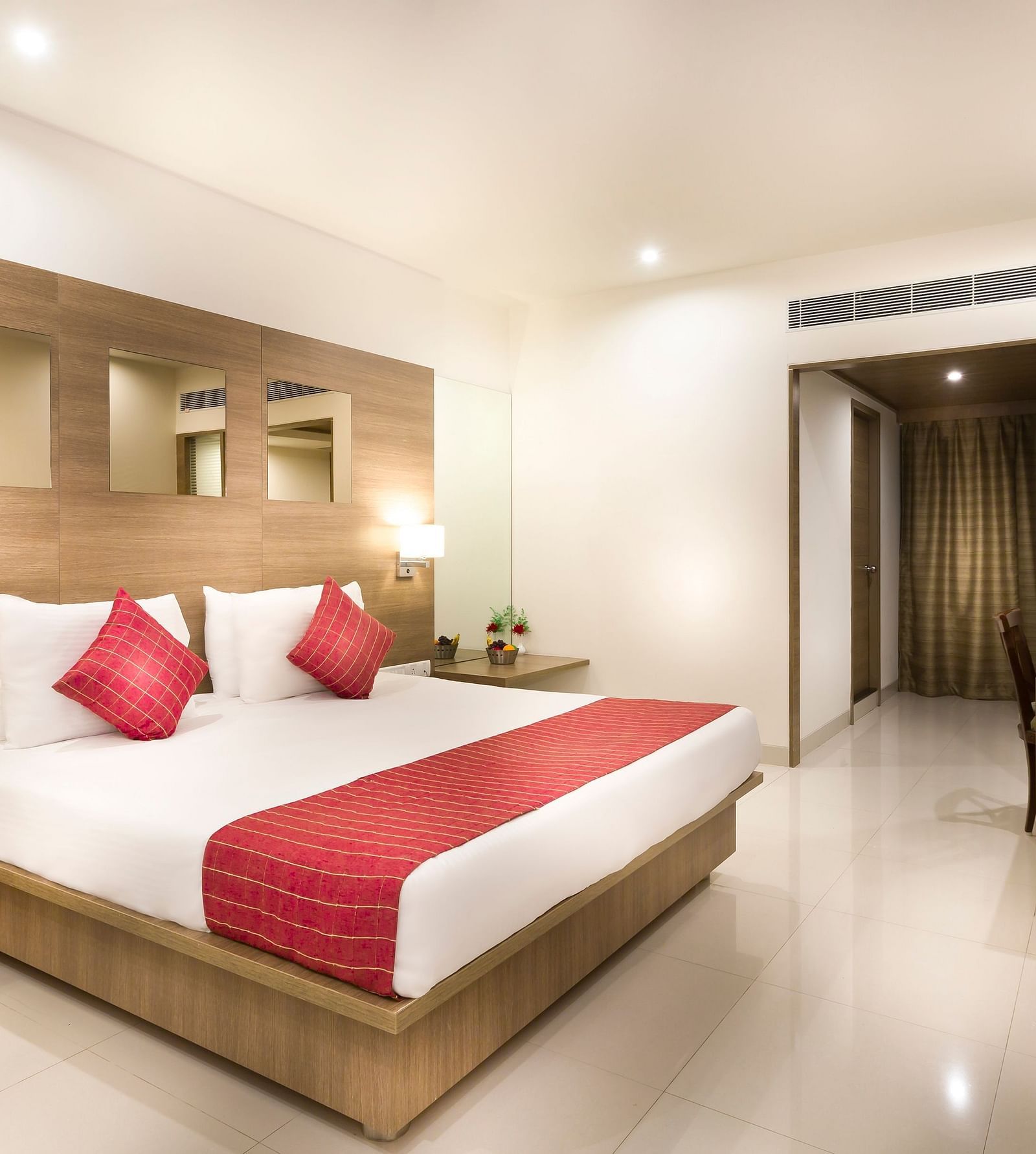 An image of a king size bed of a Deluxe Room at Regency Tiruttani by GRT Hotels.