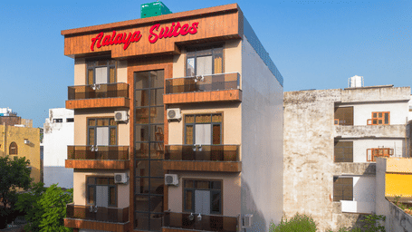 Exterior view of the multi-storey hotel building with 'Aalaya Suites' written on top under a bright blue sky - Perfectstayz Value Aalaya Suites, Haridwar
