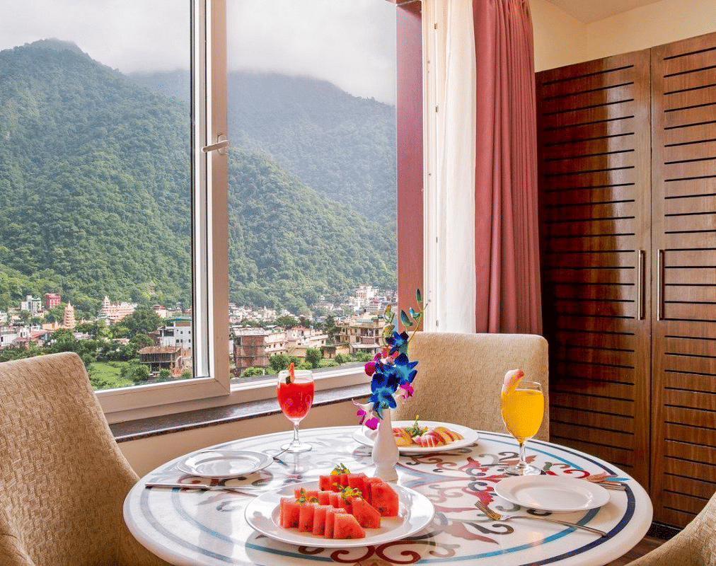 A beautifully set dining table in the suite served with fruits and juice at DLS Hotels on the Ganges.